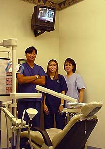 Dr. Joe Miranda and staff in a dental room with TV